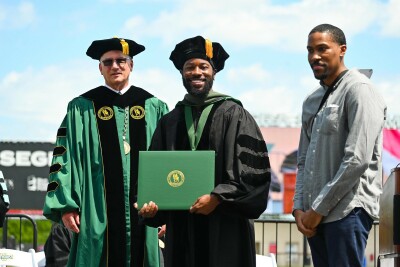 Cameron Harris receives his diploma from President Stanley T. Wearden