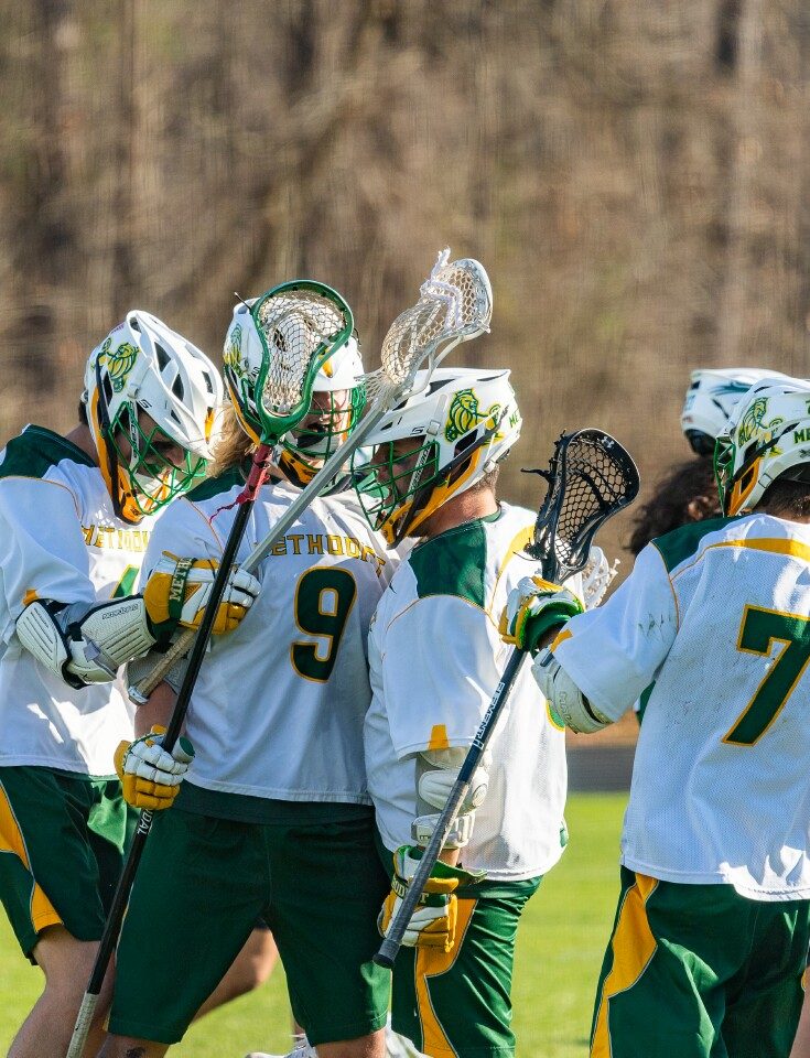 The Men's Lacrosse Team celebrates a goal