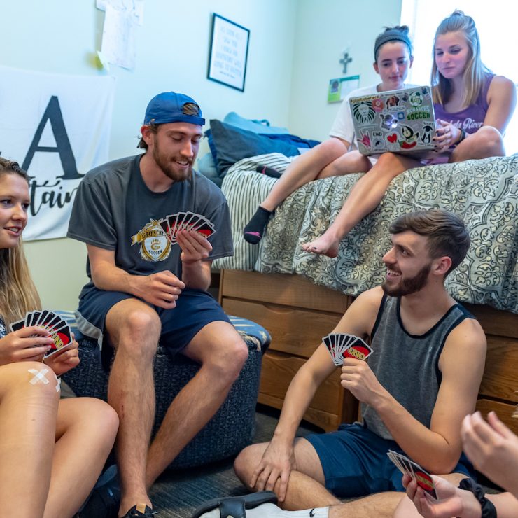 Students hanging out and playing cards at one of Methodist University's residence halls