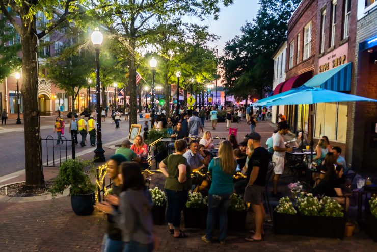 People walk across Downtown Fayetteville