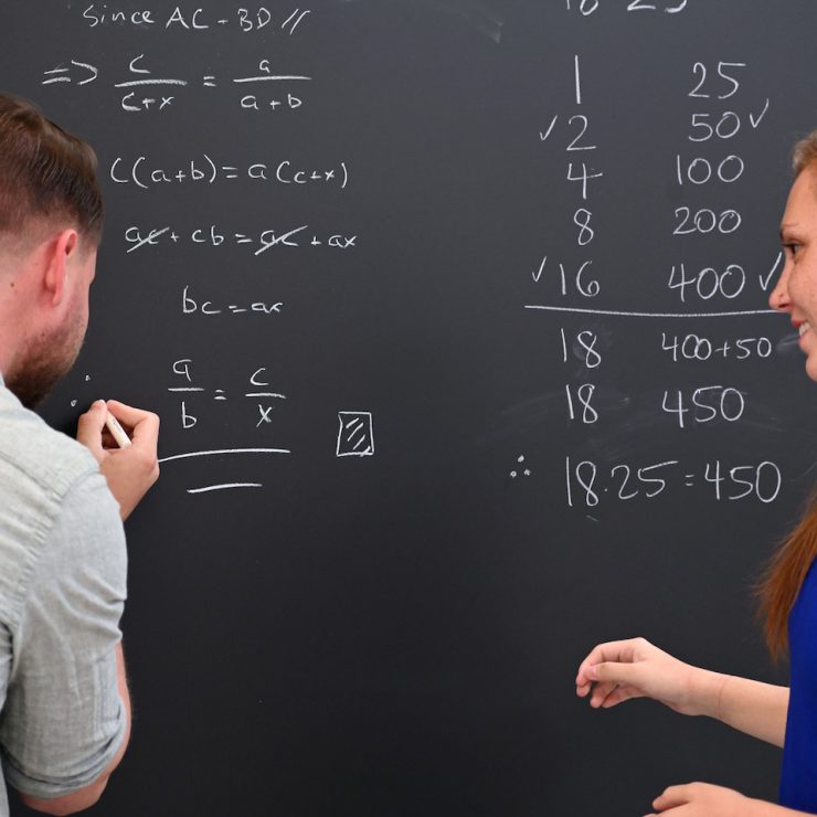 Methodist University math students working together on an equation