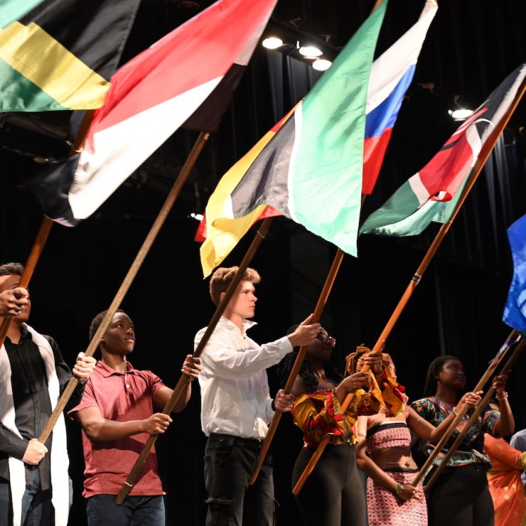 Methodist University international students holding country flags