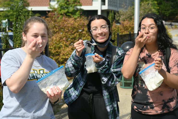 Students enjoying free food from a food truck