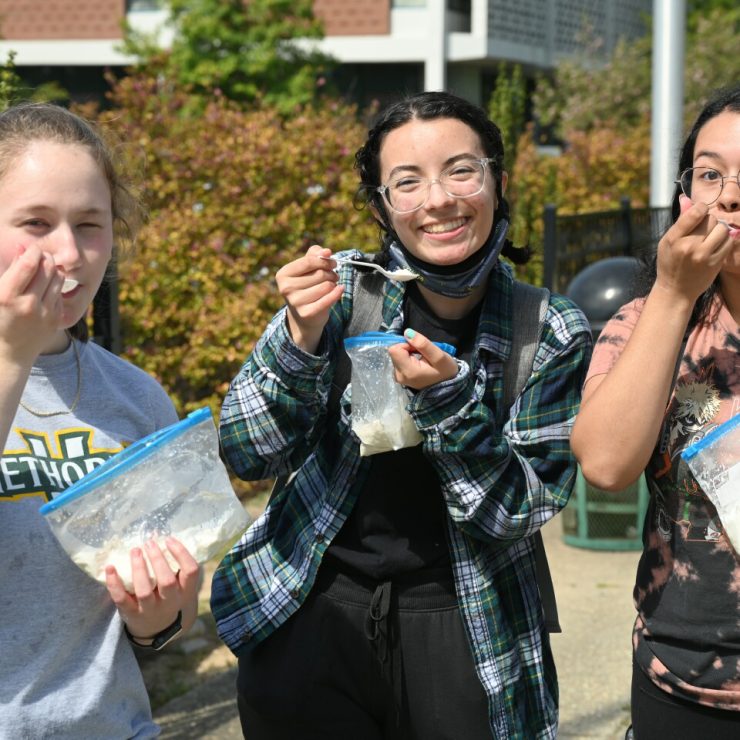 Students enjoying free food from a food truck