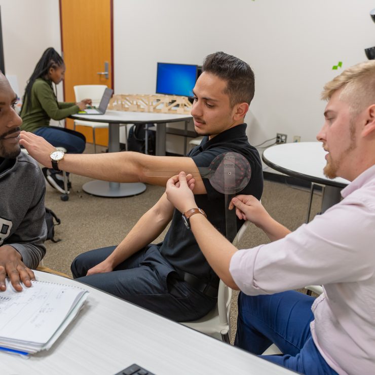 Undergraduate students work on a project together