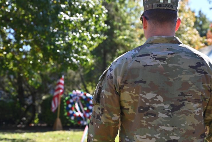 Veteran standing next to a wreath