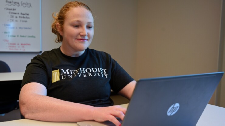 A student works on her laptop