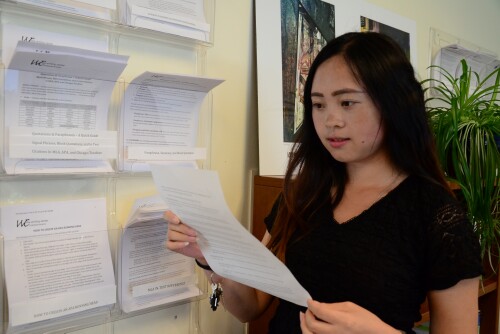 A student looks over Writing Center handouts