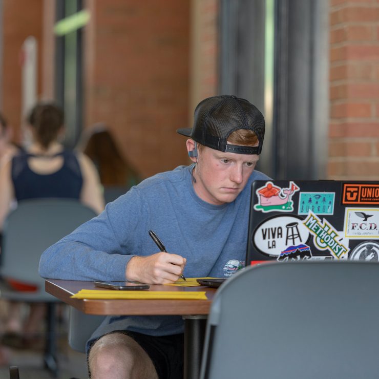 Methodist University student studies on his laptop