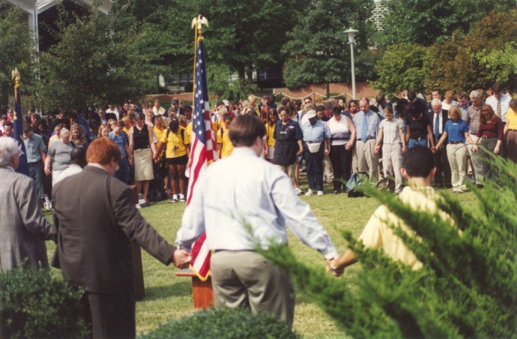 Faculty, staff and students hold a moment of silence in honor of 9/11 victims on Sept. 14, 2001