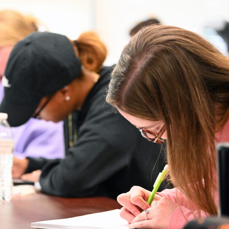 Methodist University students writing in class
