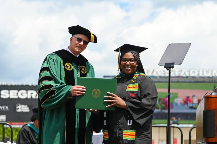 Student receives diploma from Methodist University President Stanley Wearden