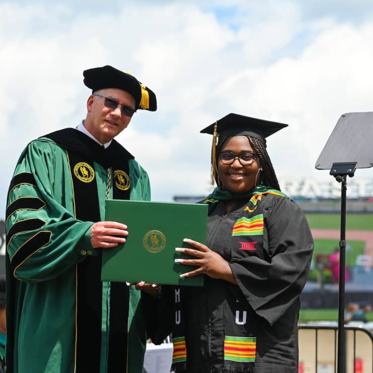 Student receives diploma from Methodist University President Stanley Wearden