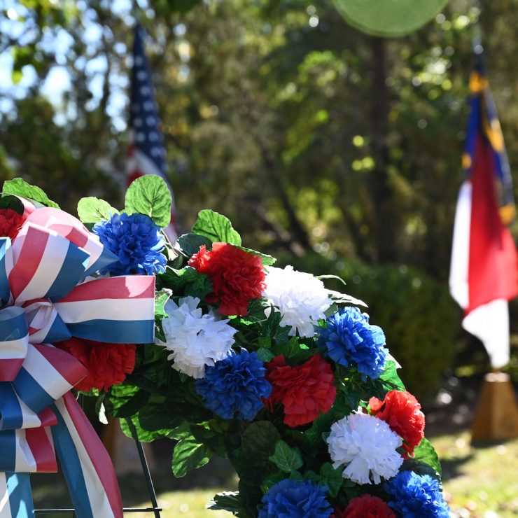 Veterans wreath in front of a North Carolina flag