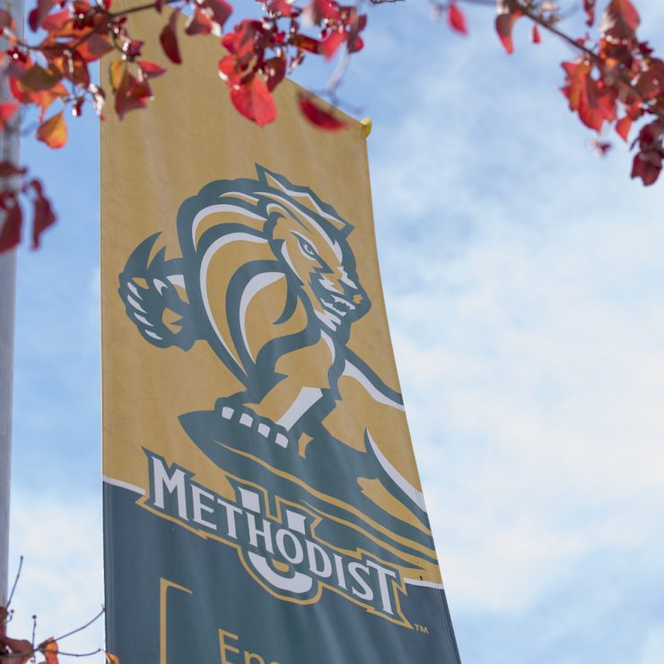 Methodist University banner with the blue sky and fall leaves
