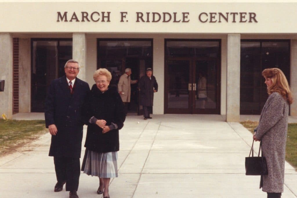 President Hendricks escorts March F. Riddle outside the Physical Activities Center named in her honor.