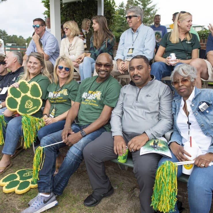 Alumni attend a home football game