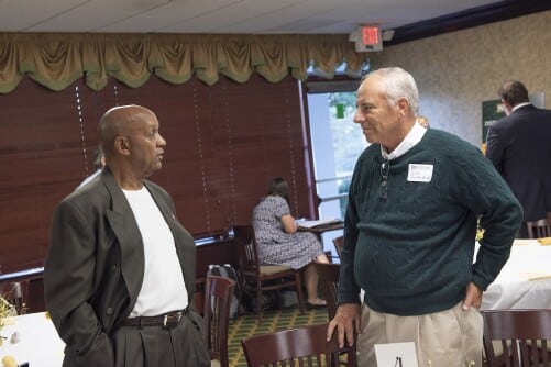 Methodist University alumni talk to one another