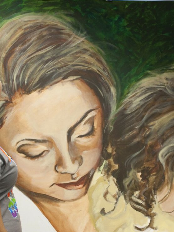 A student admires her painting