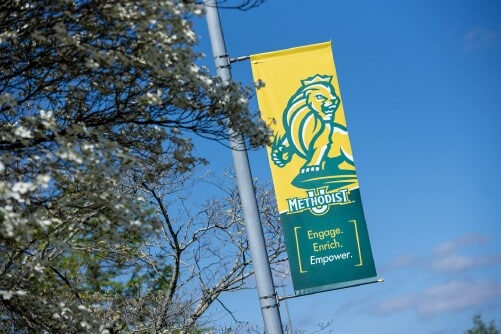 Banner next to tree at Methodist University