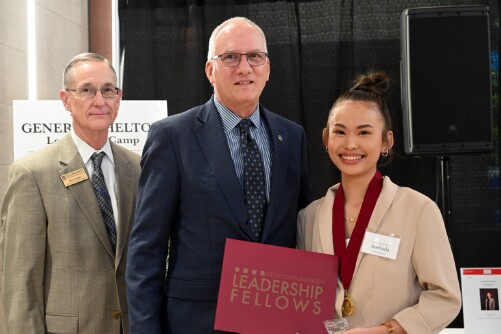 A student is awarded her Leadership Fellows certificate