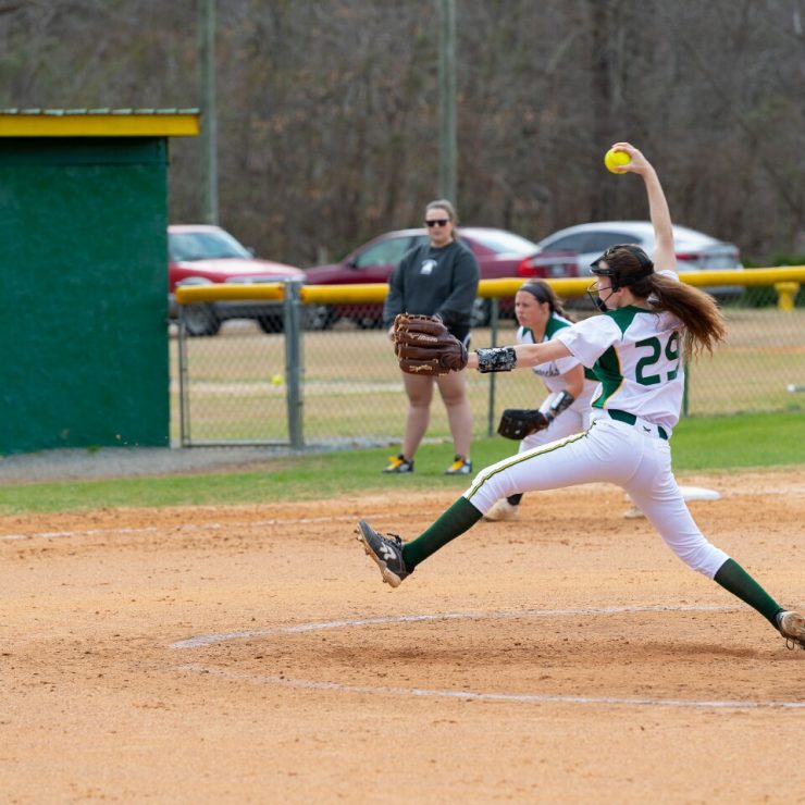 A Methodist University Softball pitcher winds up as she delivers a pitch