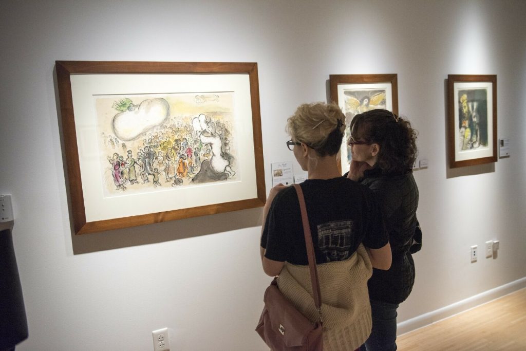 David McCune Gallery visitors enjoy the exhibit "The Story of the Exodus" by Marc Chagall