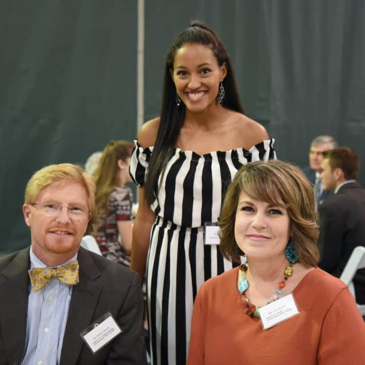 An endowed scholarship recipient poses with the donors