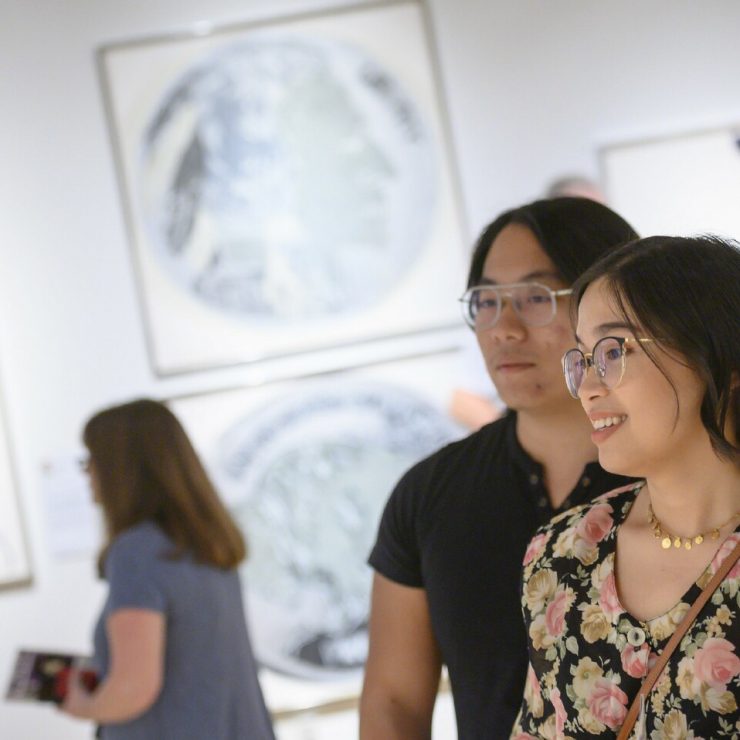 Visitors enjoy an exhibit at the David McCune International Art Gallery