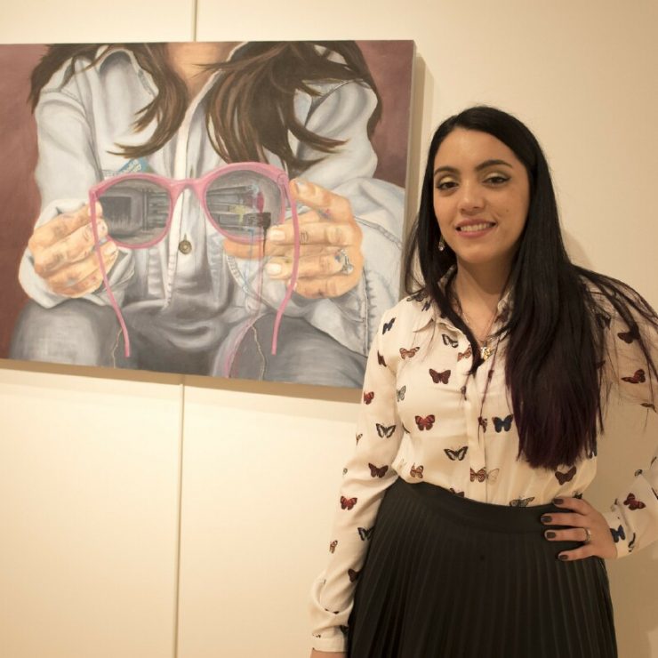 Student Loreto Oreckinto poses with her painting