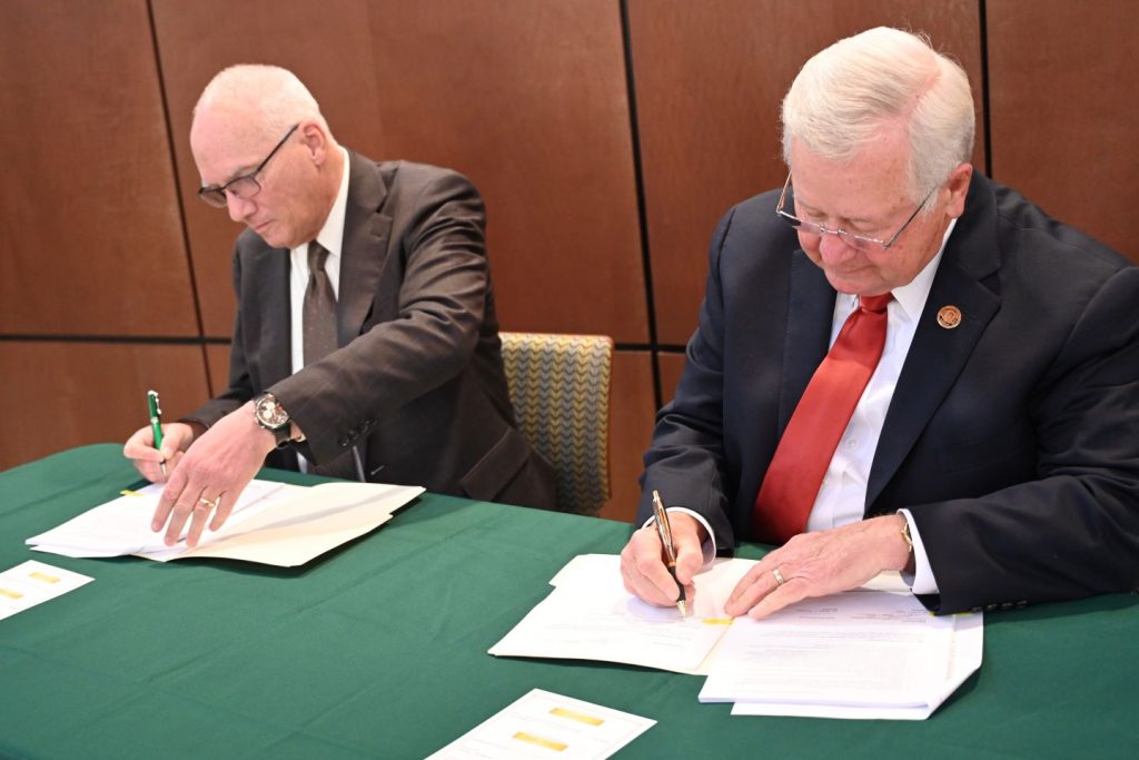 President Stan Wearden of Methodist University and President J. Larry Keen of Fayetteville Technical Community College sign a memorandum of understanding