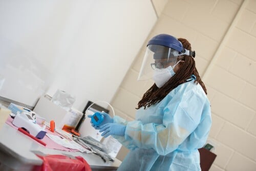 Director of Health Services Lynetta Geddie prepares a COVID-19 Test