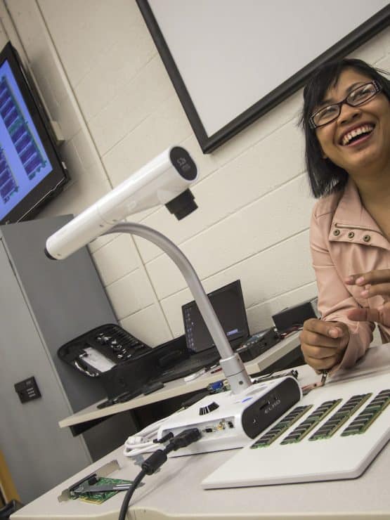 Methodist University student with computer hard drives