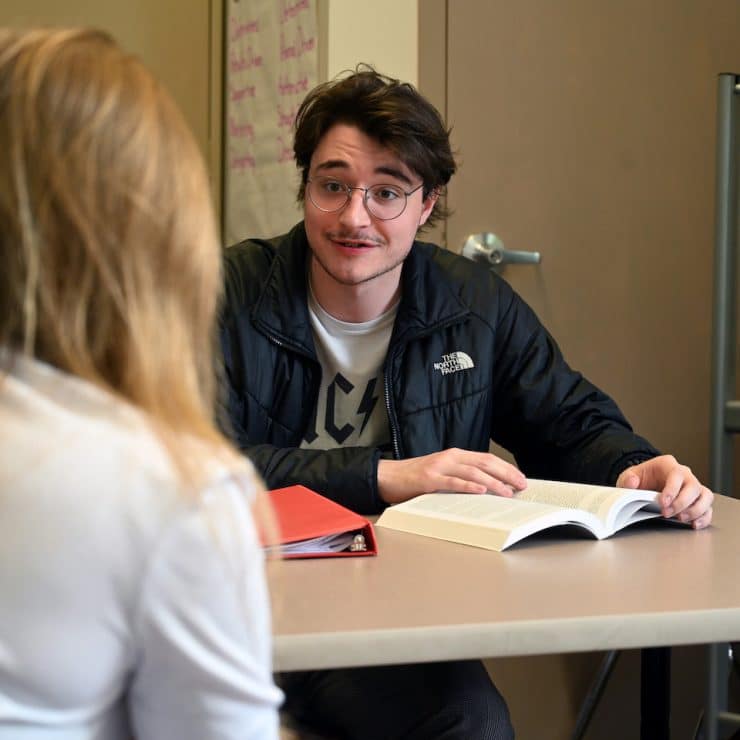 Methodist University student talks with another student