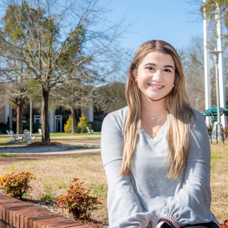 A student sitting on the quad