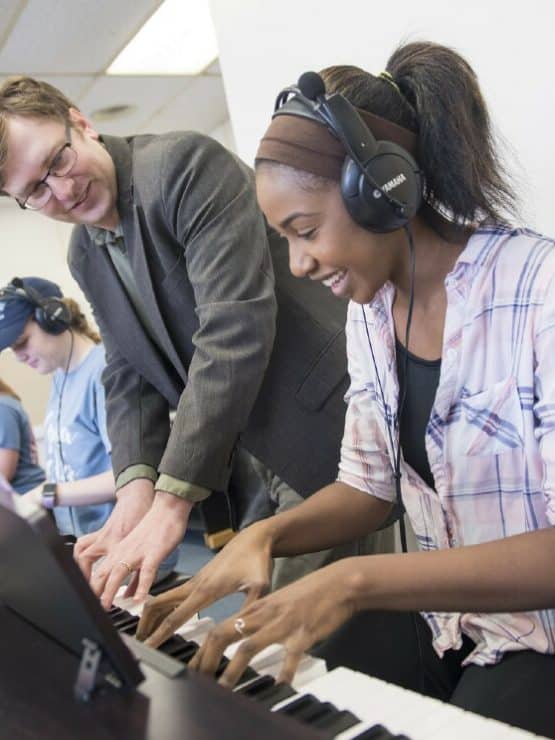 Dr. Scott Marosek working with students in the Piano Lab