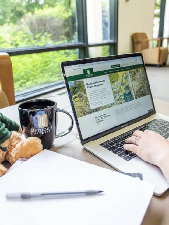 A student accesses MU Online on their laptop