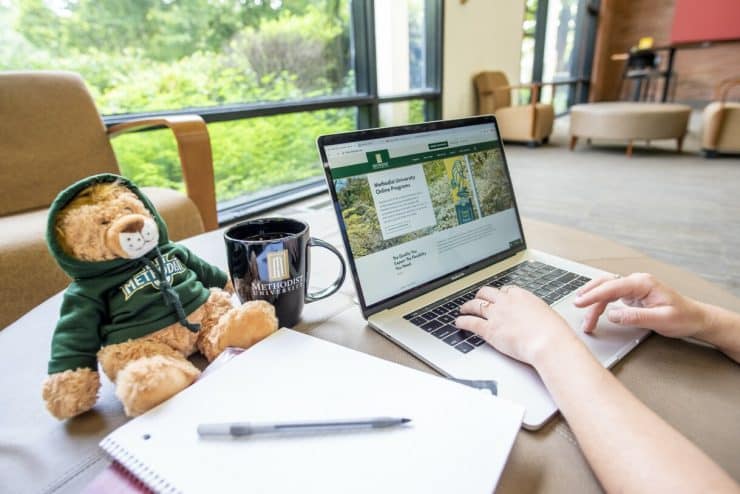 A student accesses MU Online on their laptop