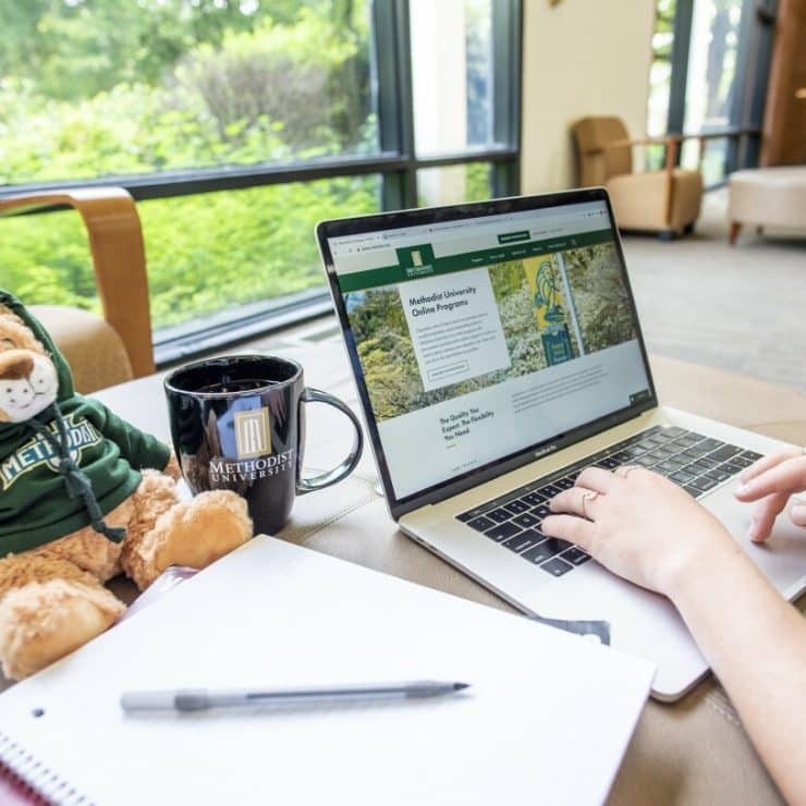 A student accesses MU Online on their laptop