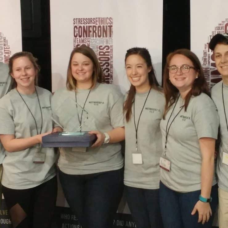 Collegiate Leadership Competition team with trophy