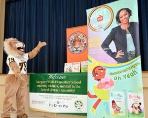 Methodist University mascot, King, presents the banners for the University's "Love of Literacy" event, which showcased an interactive reading from author Aniesha Jackson.