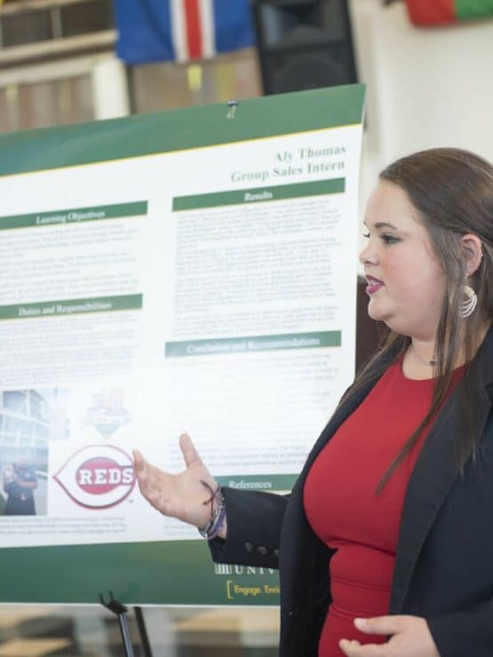 A student presents a poster at the CRC Symposium