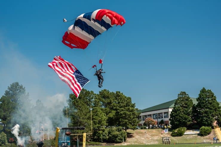 The All-Veteran Group parachute team lands on the Monarch Stadium field prior to the football game during Saturday's Military Appreciation Day at Methodist University.