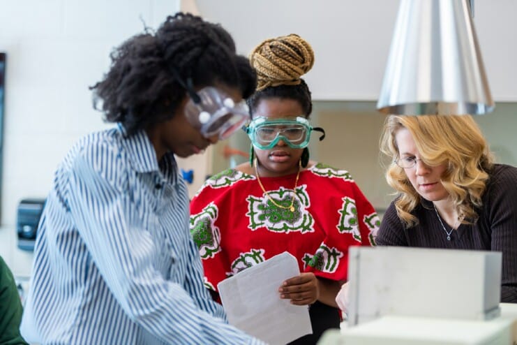 Former Methodist University students Tehilla Chinunga (left), who received a bachelor's degree in Biology, and Catia Dombaxe (center), who earned a bachelor's degree in Chemistry, work together on a project with the Head of the Division of Natural Sciences Dr. Stephanie Hooper Marosek (right).