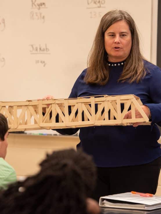Dr. Denise Bauer instructs her class how to build bridges in MU's Engineering program