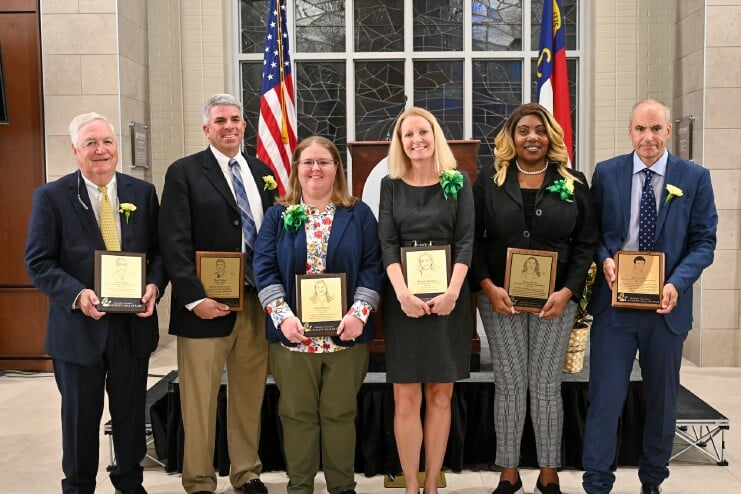 Jerry Hogge, Mark Faber ’94, Susan Martin ’10, Francie Barragan , Vivian Davis ’87, and John Storms ’90 (left to right) stand with the plaques they earned during Methodist University’s 2022 Athletic Hall of Fame induction ceremony.