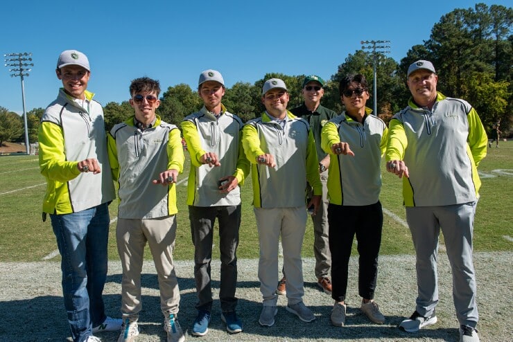 The Methodist University men’s golf team stands with MU President Stanley T. Wearden as they show off their newly-earned National Championship rings.