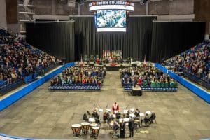 A large gathering of family, friends, and loved ones watch Methodist University’s 50th Winter Commencement at Crown Coliseum.