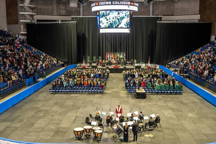 A large gathering of family, friends, and loved ones watch Methodist University’s 50th Winter Commencement at Crown Coliseum.