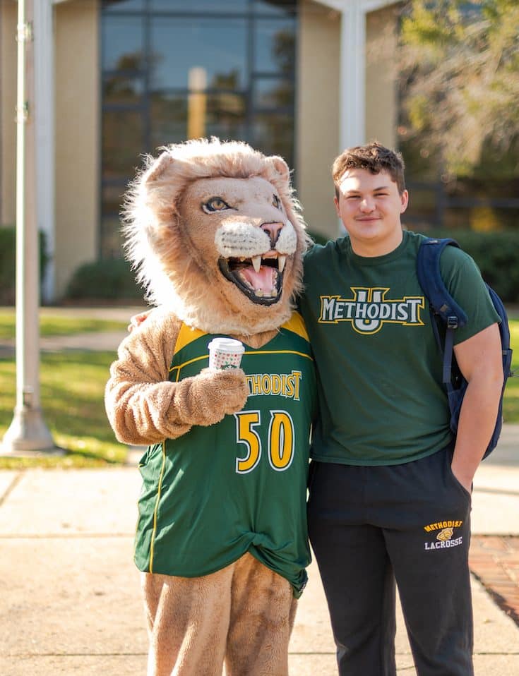 Methodist University mascot King poses with a student on the first day of classs